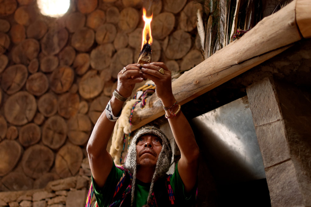 Huachuma shaman from Chavin de Huantar, Peru. He is holding the burning Palo Santo wood in his hand.
