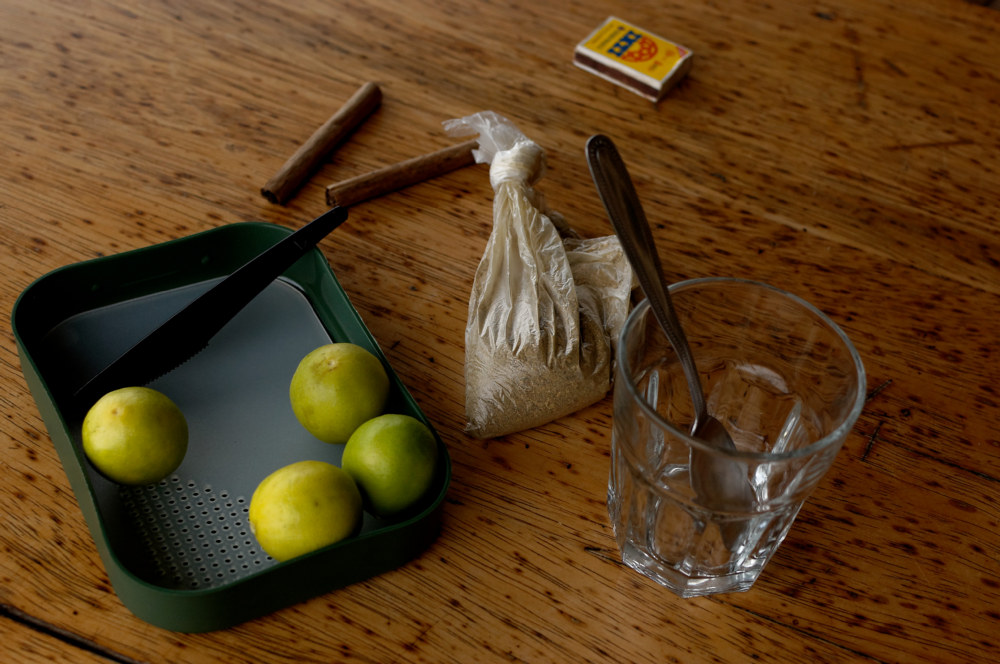 Limons and plastic bag with san pedro powder on a table.